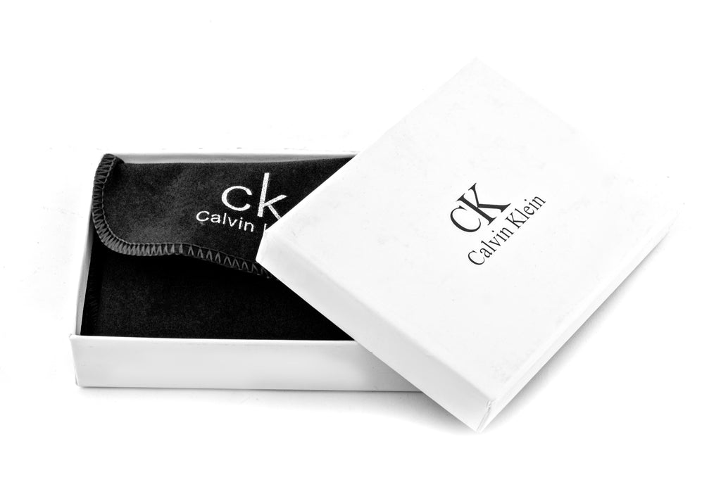 Calvin Klein features an all-over embossed CK monogram pattern on smooth black leather